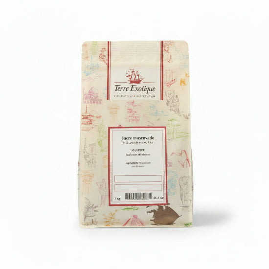 A 1 kg paper bag of Terre Exotique Sucre muscovado (Maurelle) sugar, decorated with light pink and multicolor illustrations, set against a solid beige background.