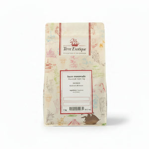 A 1 kg paper bag of Terre Exotique Sucre muscovado (Maurelle) sugar, decorated with light pink and multicolor illustrations, set against a solid beige background.