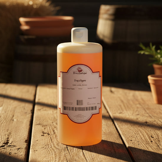 A 1-liter plastic bottle of Terre exotique Syrup d'Agave with a white cap and a white label featuring red borders, set against a plain white background.