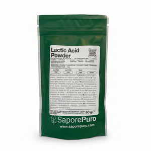 A green bag of SaporePuro Lactic Acid Powder with a white label, photographed standing upright on a clear plastic surface in a store setting.